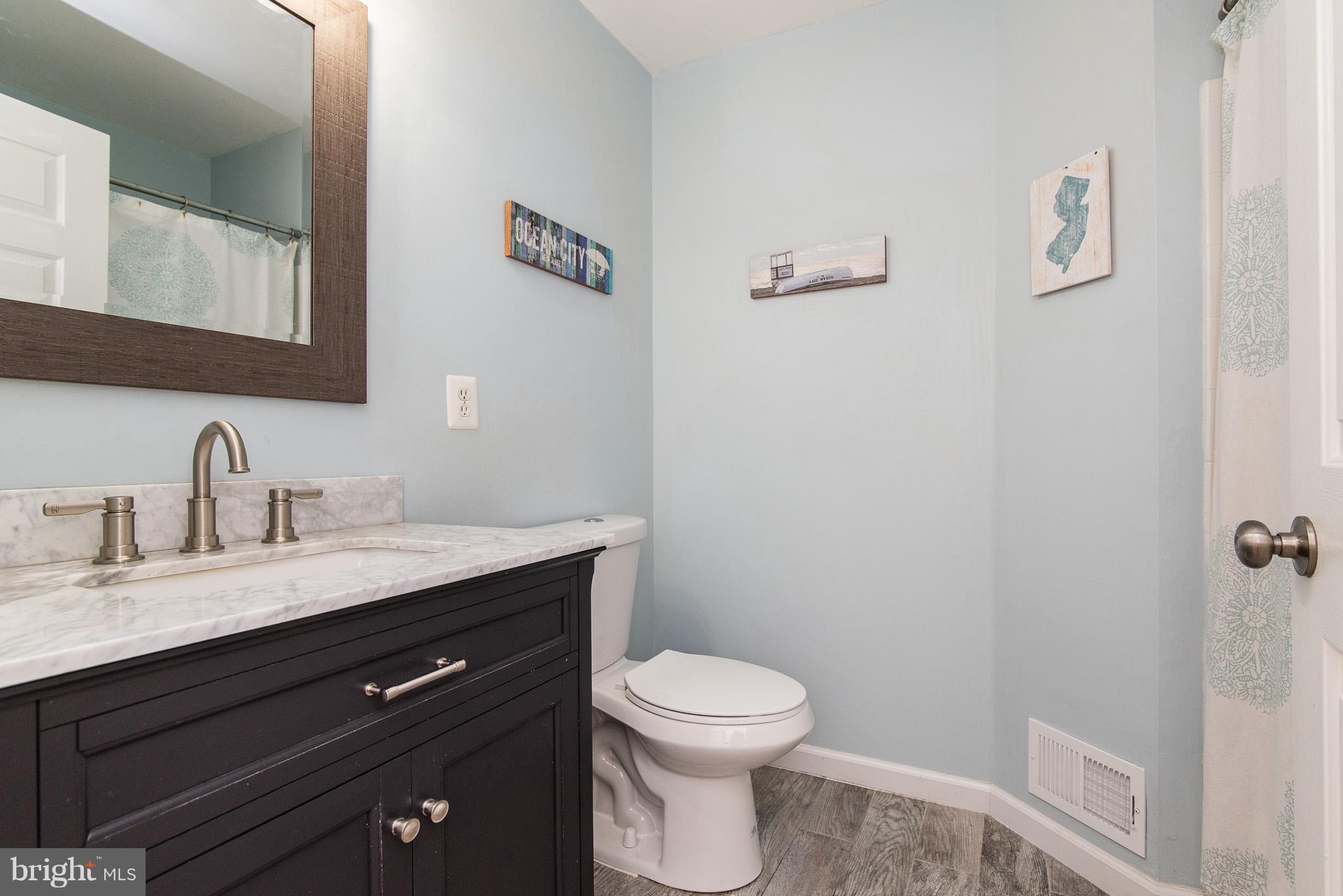 583 Henderson Road Bel Air, MD 21014 - Photo 29 of 42 a bathroom with a granite countertop sink a toilet and a mirror