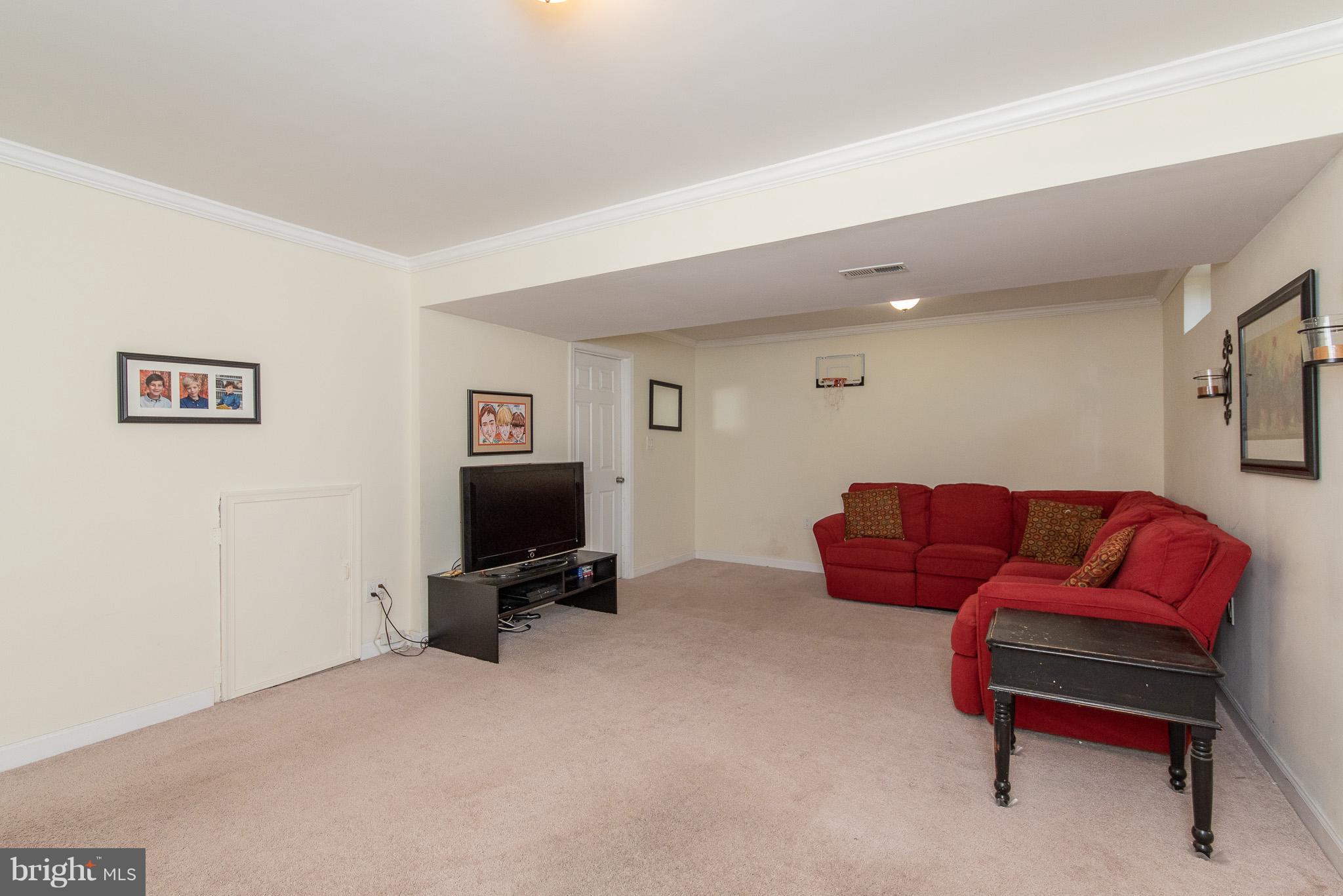 583 Henderson Road Bel Air, MD 21014 - Photo 36 of 42 a living room with furniture and a flat screen tv