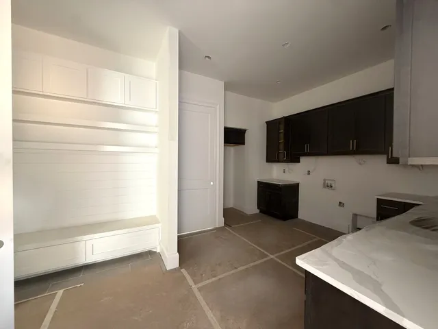a kitchen with stainless steel appliances a stove sink microwave and cabinets