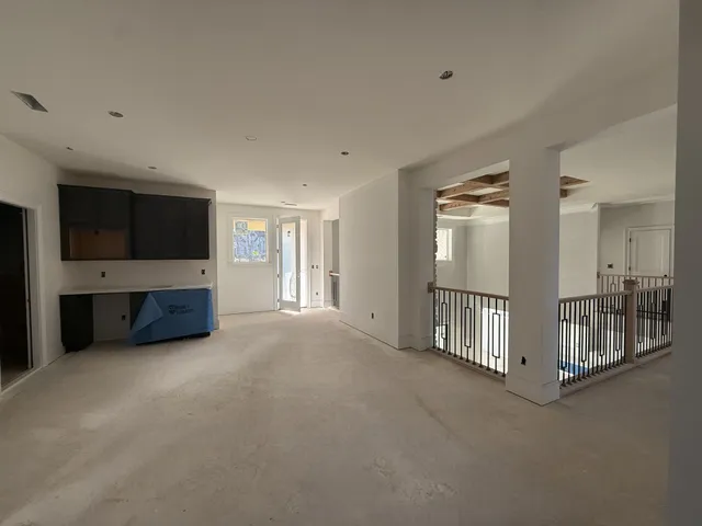 an empty room with windows and closet in it