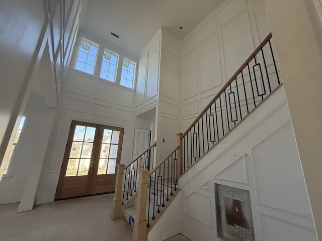 a view of staircase and hallway with windows