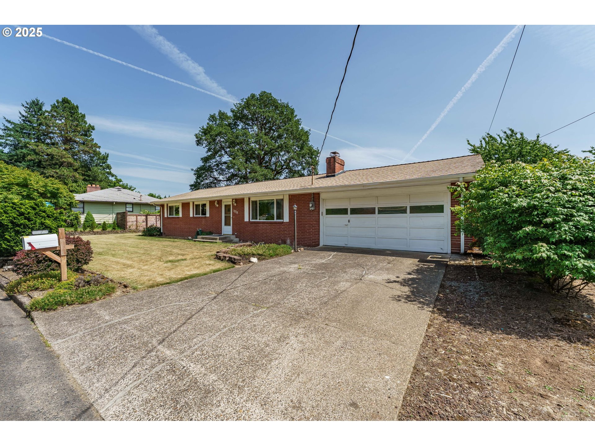 1938 Northwest Sierra Lane Camas, WA 98607 - Photo 2 of 33 a view of a house with a backyard and a garage