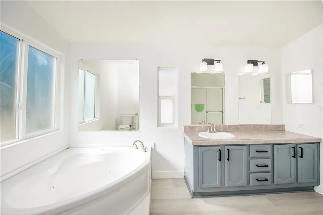 1051 Site, Unit 31 Brea, CA 92821 - Photo 21 of 35 a bathroom with a tub a sink and a large mirror