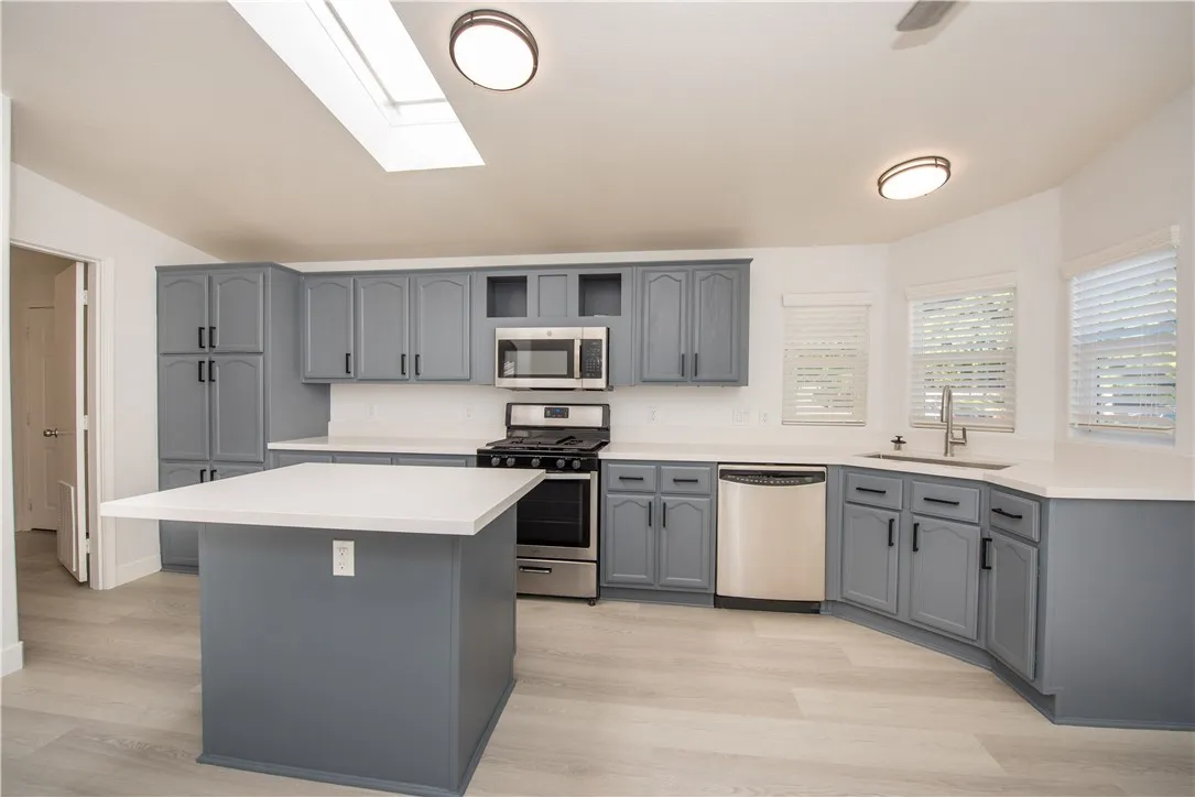 1051 Site, Unit 31 Brea, CA 92821 - Photo 6 of 35 a kitchen with stainless steel appliances granite countertop a stove top oven sink and white cabinets