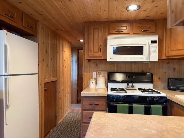 a kitchen with stainless steel appliances granite countertop a refrigerator and a stove