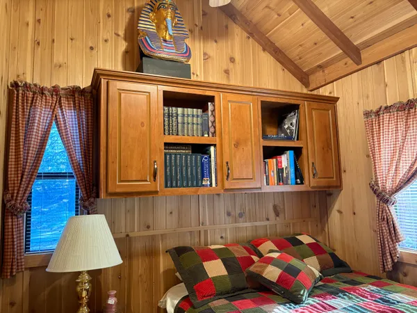 a bedroom with a bed and a book shelf