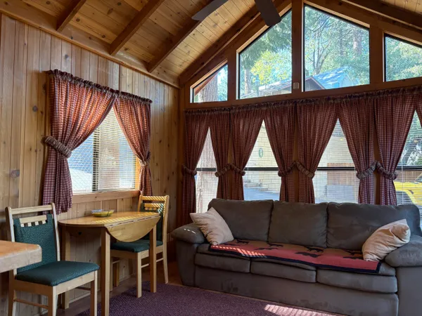 a living room with furniture a window and a table