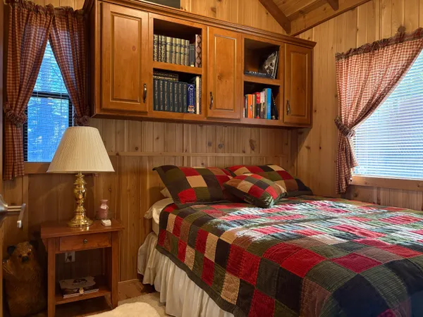 a bed sitting in a bedroom next to a window