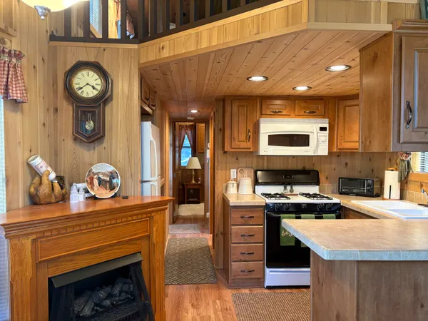 a kitchen with stainless steel appliances granite countertop a stove and a clock