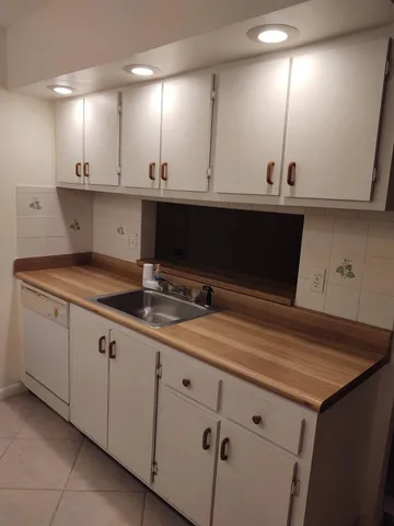 a kitchen with a sink and cabinets