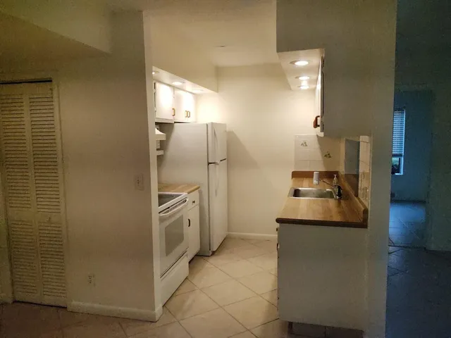 a kitchen with stainless steel appliances granite countertop a refrigerator and a stove