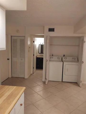 a utility room with cabinets washer and dryer