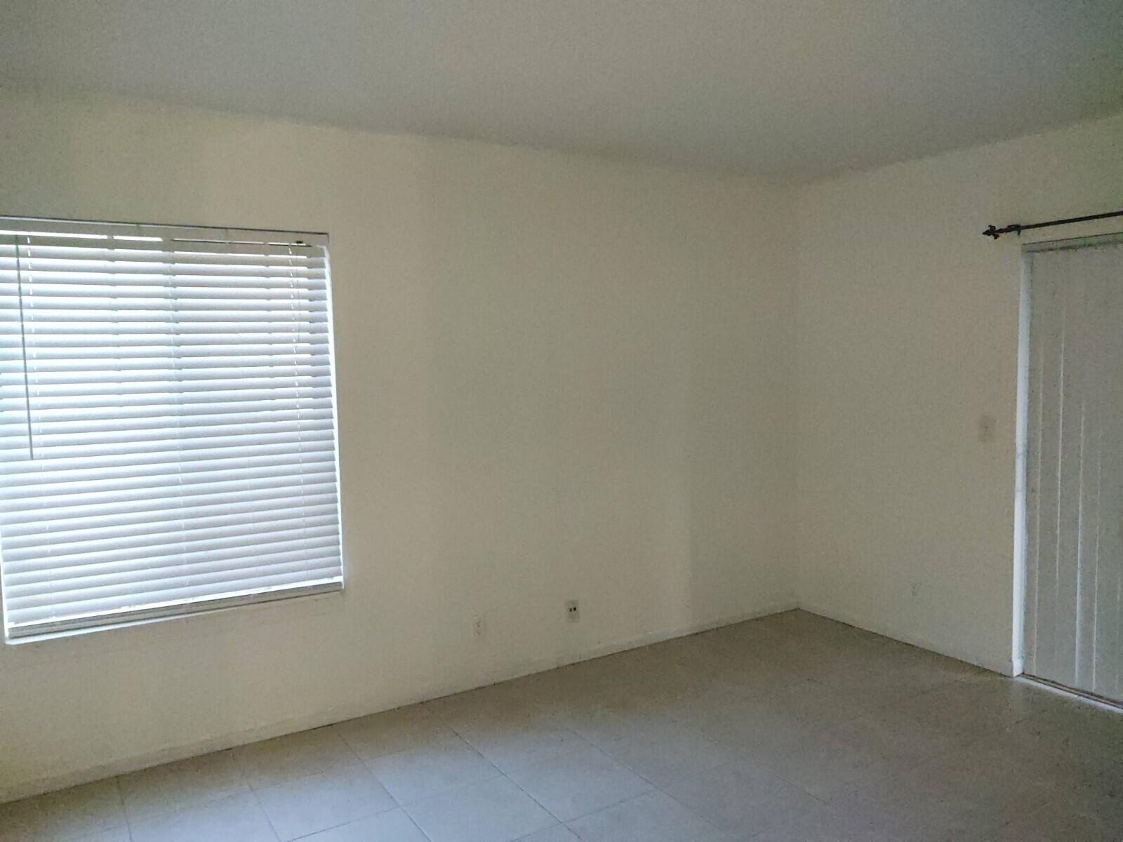 6341 Chasewood Drive, Unit B Jupiter, FL 33458 - Photo 10 of 14 an empty room with a window