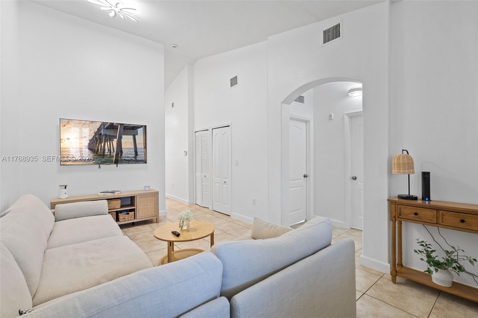 a living room with furniture and a flat screen tv