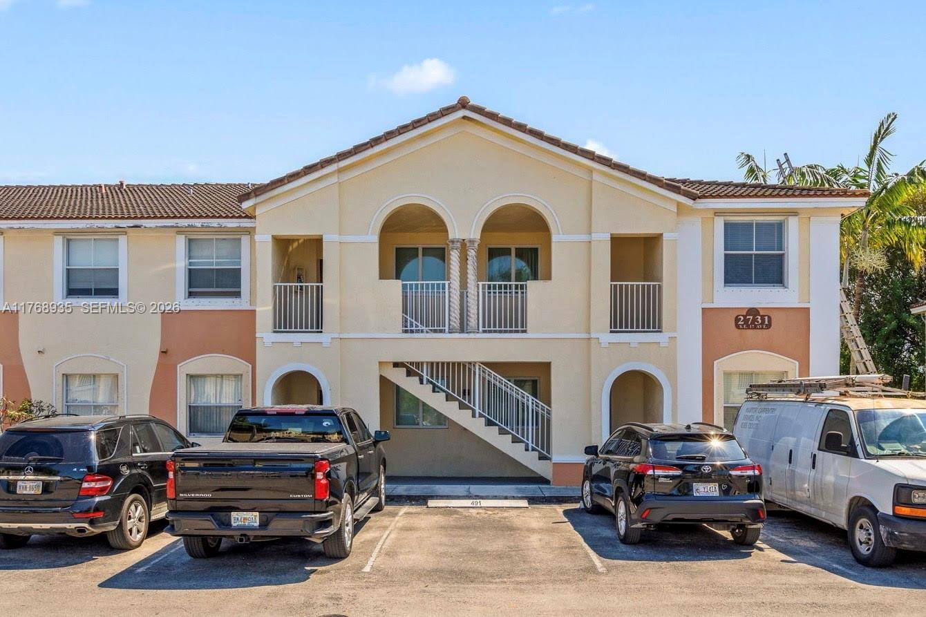 2731 Southeast 17th Avenue, Unit 211 Homestead, FL 33035 - Photo 3 of 26 a car parked in front of a house