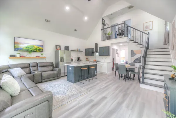 a living room with furniture and a kitchen view