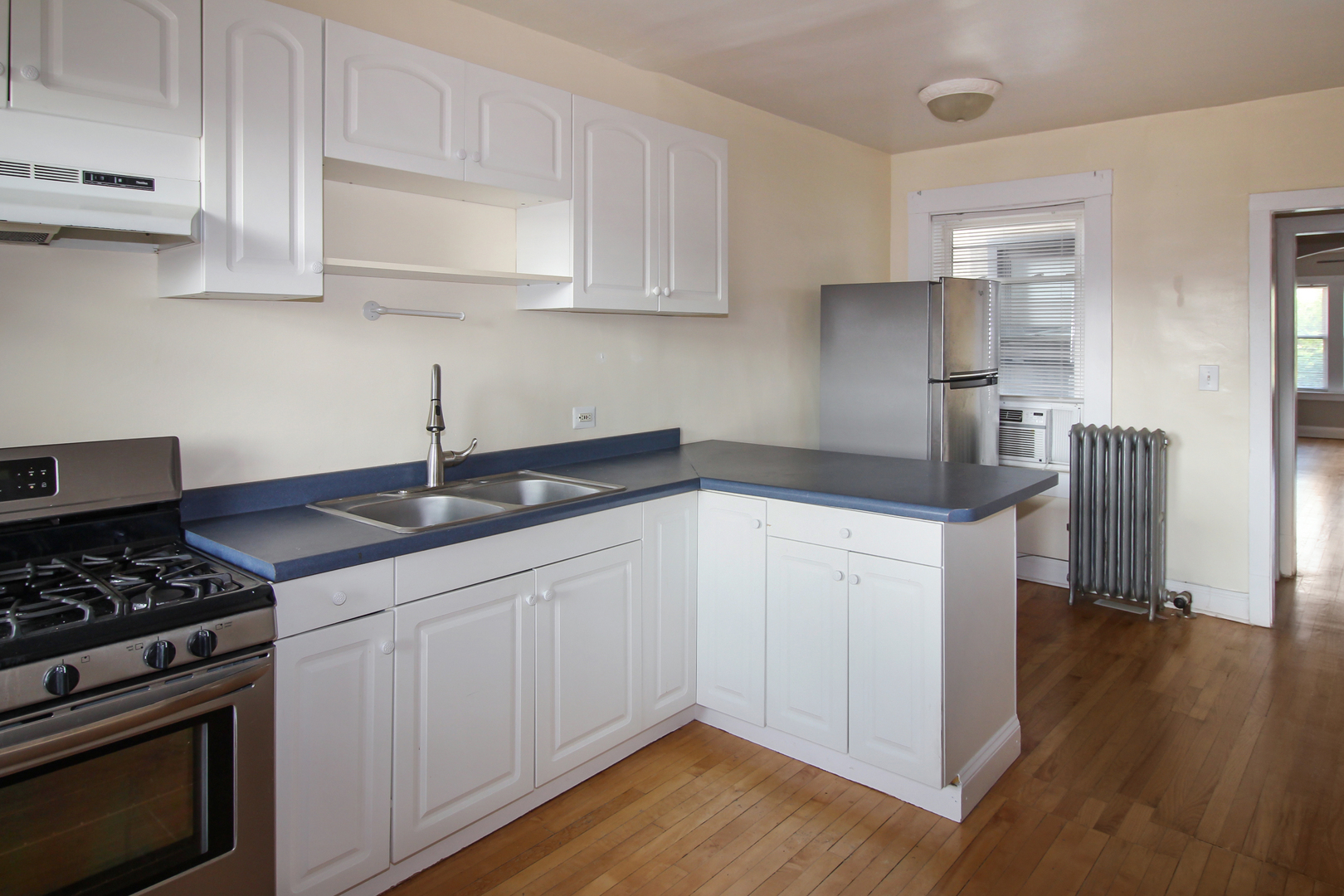 125 North Addison Avenue, Unit 3 Elmhurst, IL 60126 - Photo 9 of 16 a kitchen with granite countertop a sink cabinets and stainless steel appliances