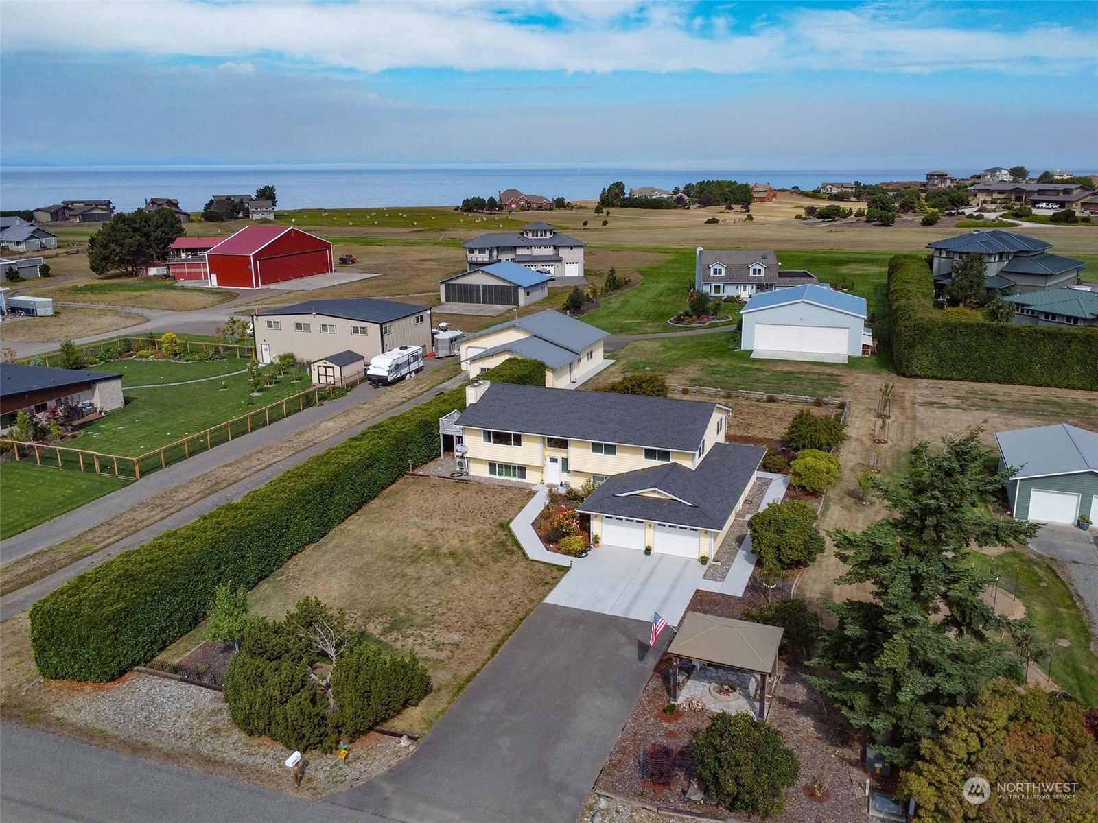 an aerial view of a house with a garden and mountain view in back