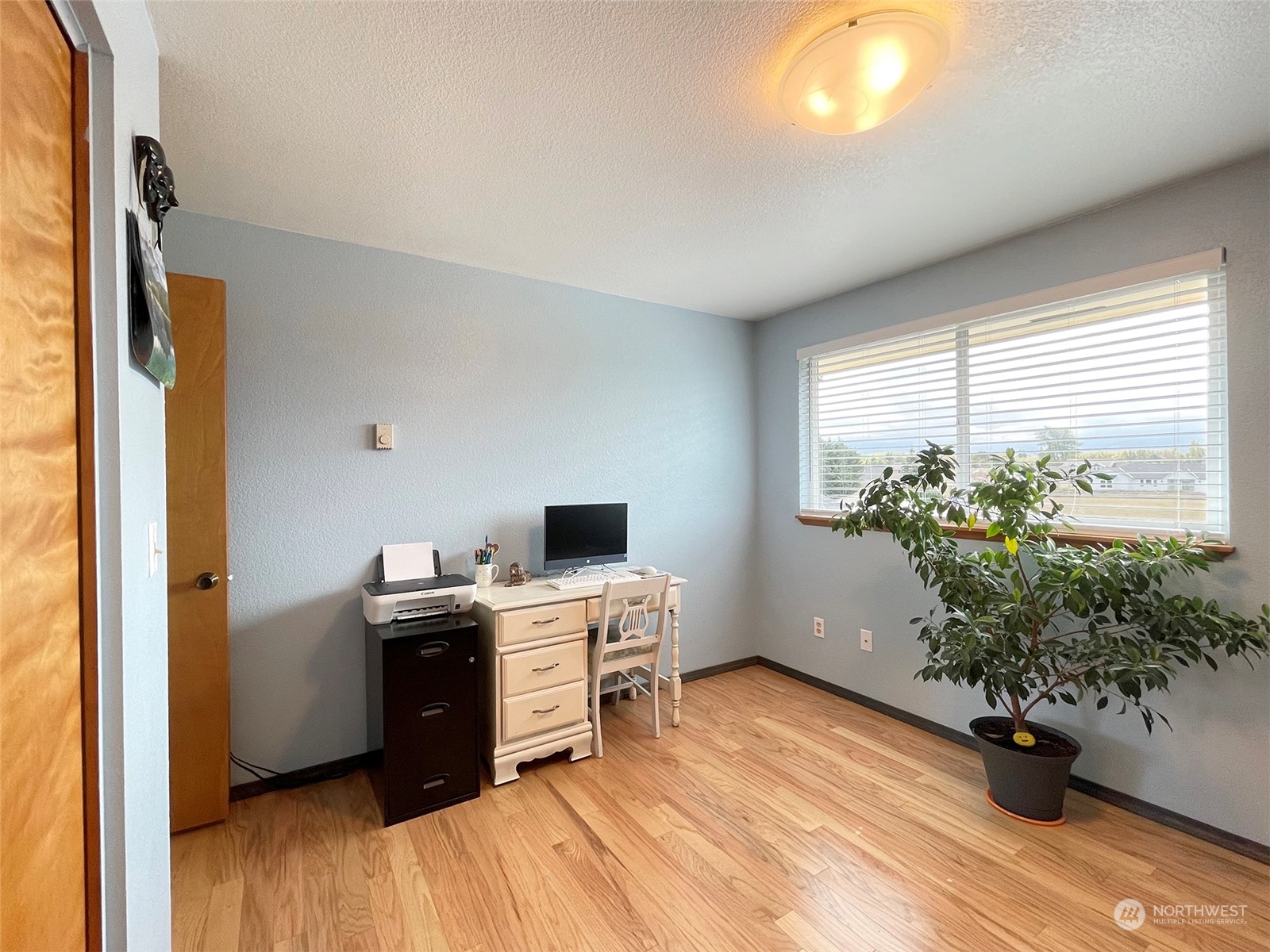 190 Greywolf Road Sequim, WA 98382 - Photo 18 of 40 a kitchen with a potted plant on the counter and a wooden floor
