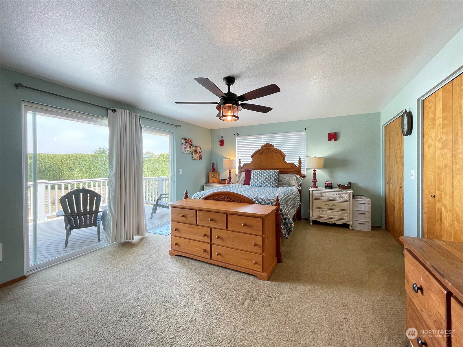 190 Greywolf Road Sequim, WA 98382 - Photo 21 of 40 a spacious bedroom with a bed and a large window
