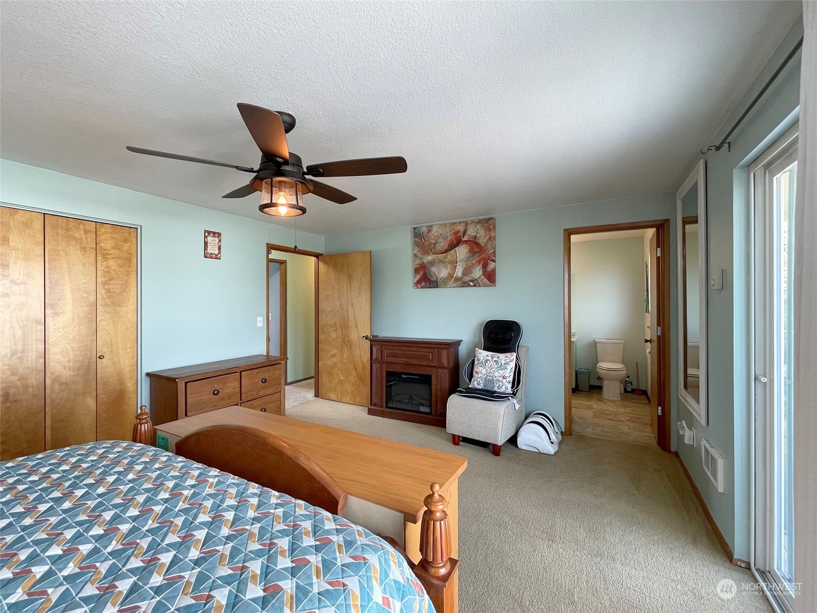 190 Greywolf Road Sequim, WA 98382 - Photo 22 of 40 a bedroom with a bed and dresser with mirror