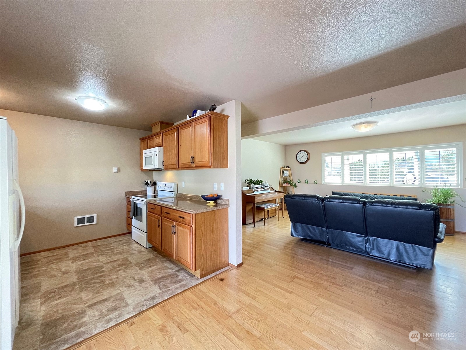 190 Greywolf Road Sequim, WA 98382 - Photo 28 of 40 a kitchen with sink window and wooden floor