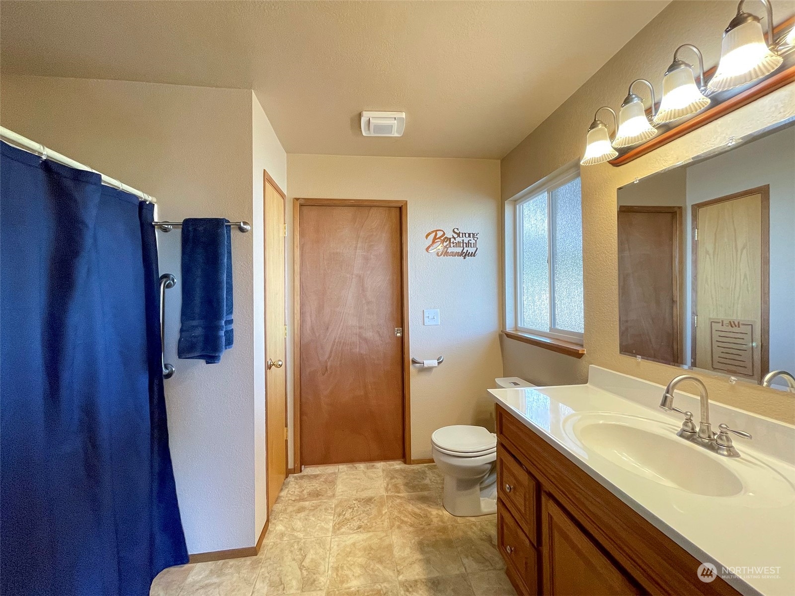 190 Greywolf Road Sequim, WA 98382 - Photo 32 of 40 a bathroom with a sink a toilet a mirror and shower