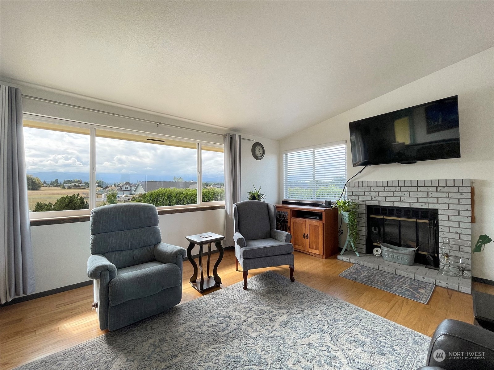 190 Greywolf Road Sequim, WA 98382 - Photo 6 of 40 a living room with furniture a fireplace and a flat screen tv