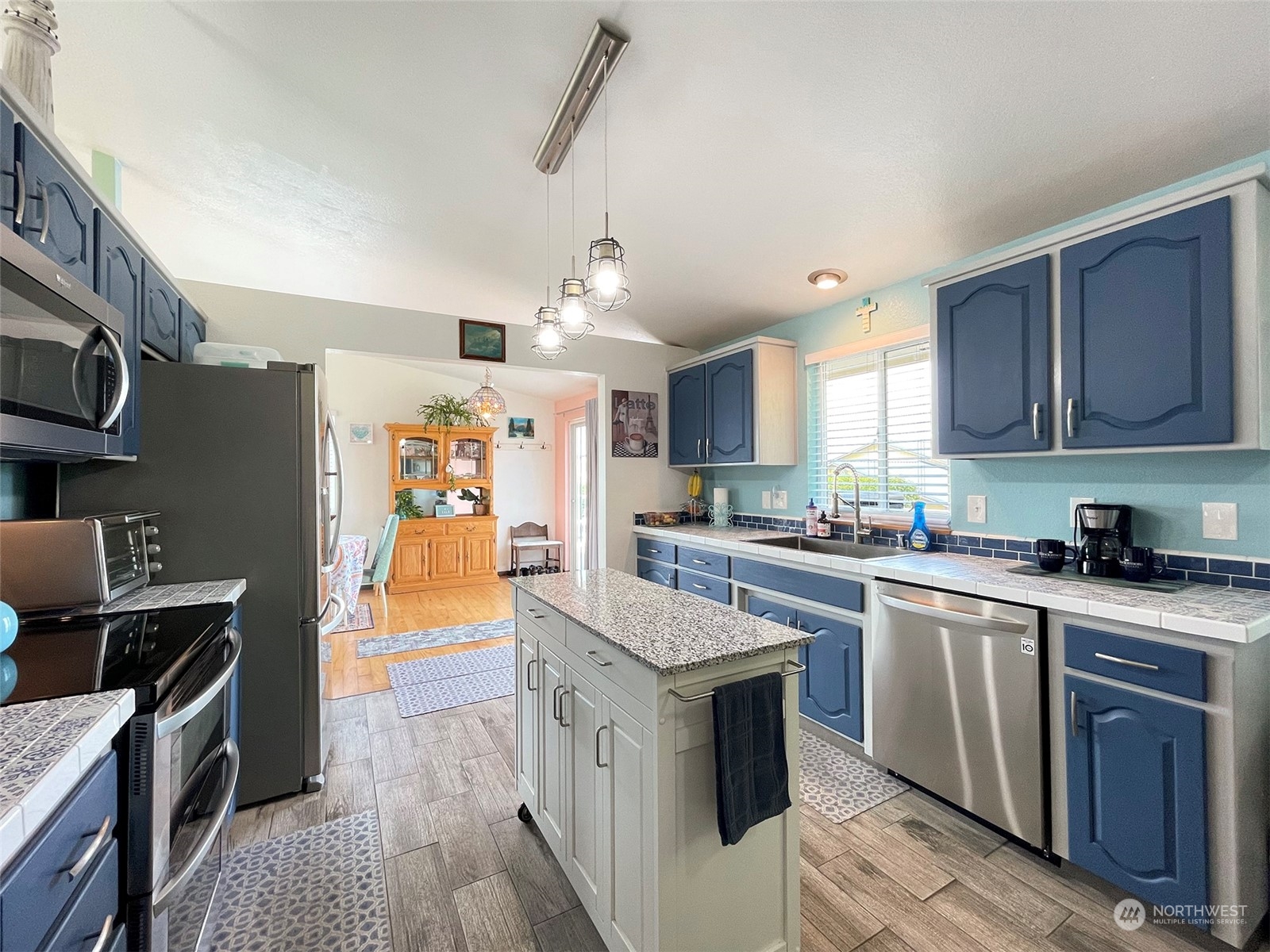 190 Greywolf Road Sequim, WA 98382 - Photo 10 of 40 a kitchen with stainless steel appliances granite countertop a stove cabinets and wooden floor