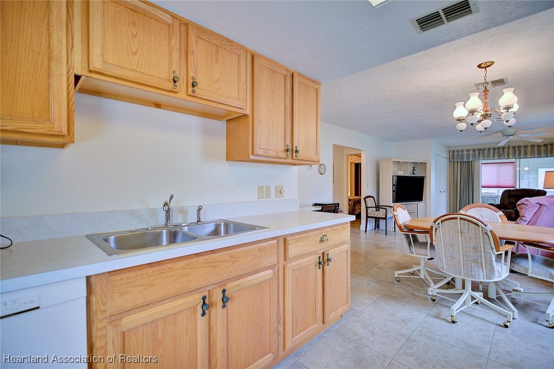 1815 Key Lake Drive Sebring, FL 33875 - Photo 11 of 41 a kitchen with a sink cabinets and dining table
