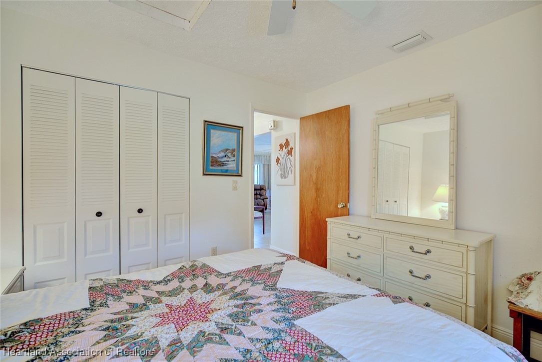 1815 Key Lake Drive Sebring, FL 33875 - Photo 20 of 41 a bedroom with a bed and a dresser in it