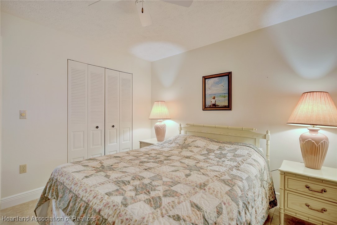 1815 Key Lake Drive Sebring, FL 33875 - Photo 24 of 41 a bedroom with a bed and a lamp