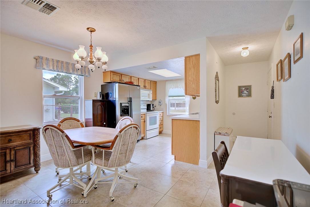 1815 Key Lake Drive Sebring, FL 33875 - Photo 3 of 41 a view of a dining room with furniture and chandelier