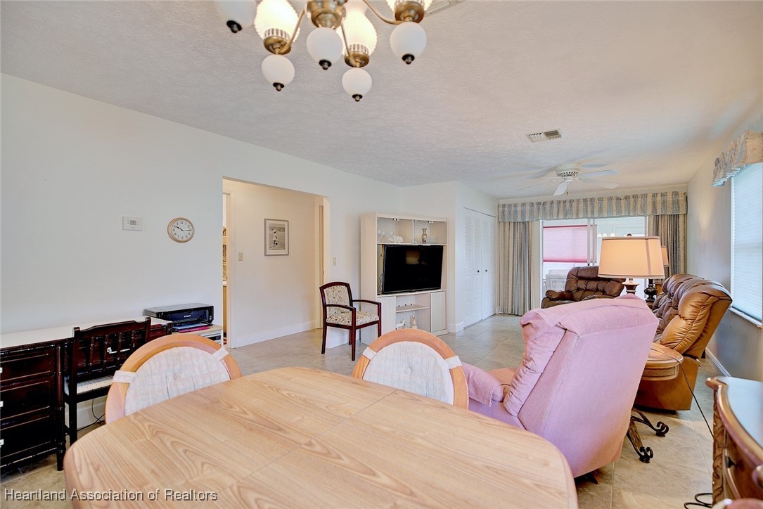 1815 Key Lake Drive Sebring, FL 33875 - Photo 7 of 41 a bedroom with a bed a chandelier and dresser