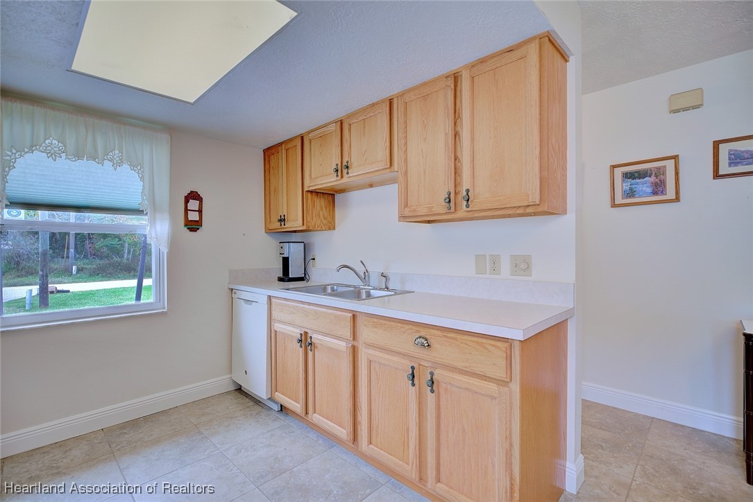 1815 Key Lake Drive Sebring, FL 33875 - Photo 8 of 41 a kitchen with a sink cabinets and a window