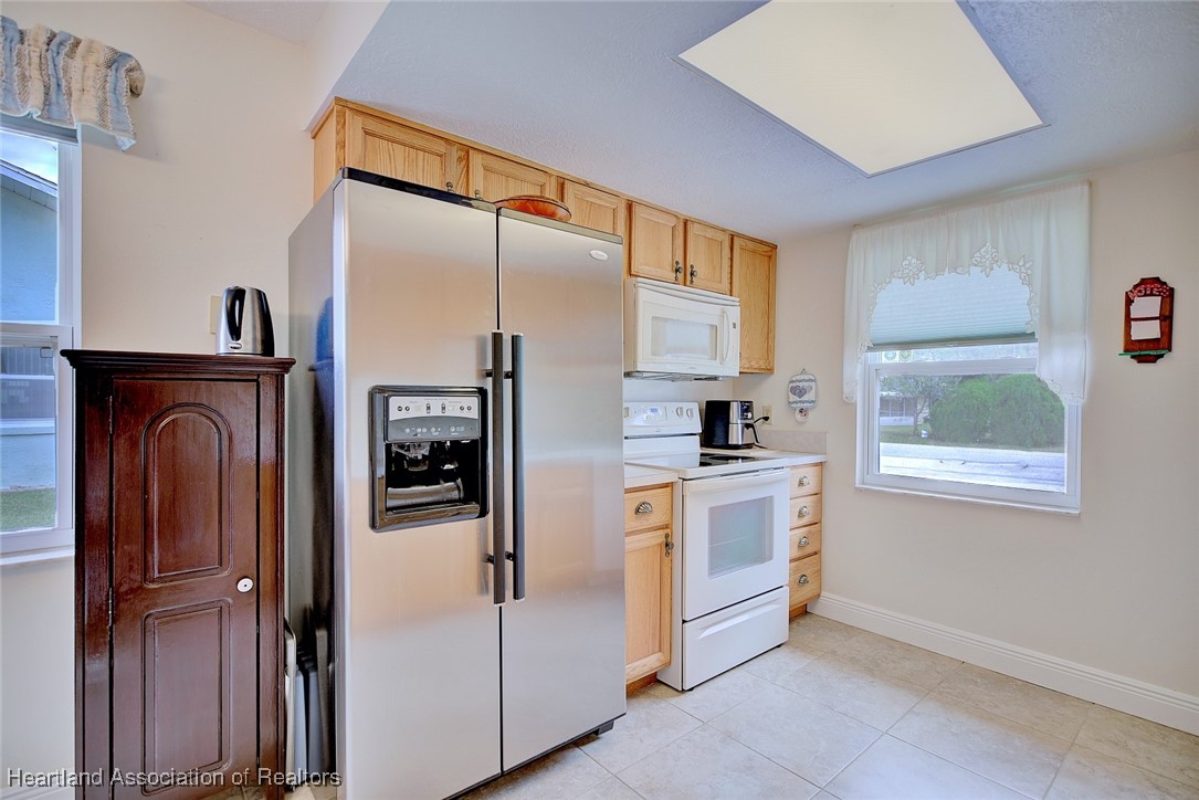 1815 Key Lake Drive Sebring, FL 33875 - Photo 9 of 41 a kitchen with stainless steel appliances a refrigerator sink and cabinets