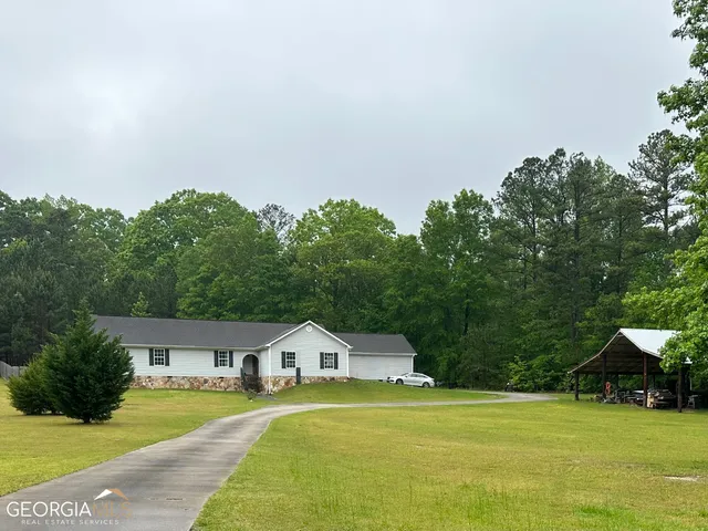 a front view of a house with a yard garage and outdoor seating