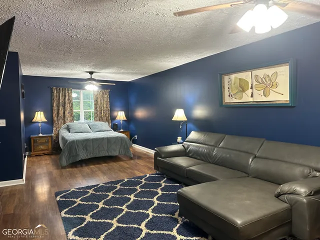 a bedroom with furniture and a lamp