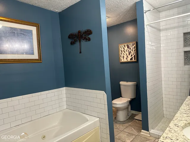 a bathroom with a toilet and a shower curtain
