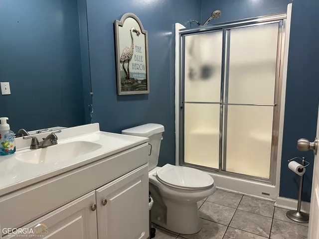 a bathroom with a toilet sink and shower