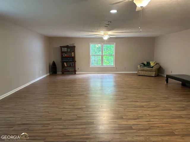 a view of room with window and wooden floor