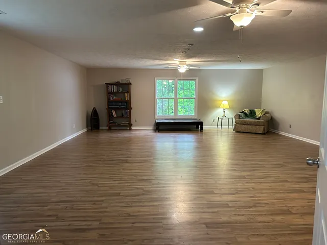a view of a room with window and wooden floor