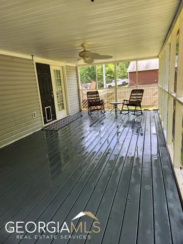 a sitting area with lamp on deck