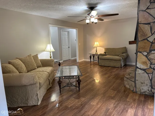 a living room with couches and a chandelier