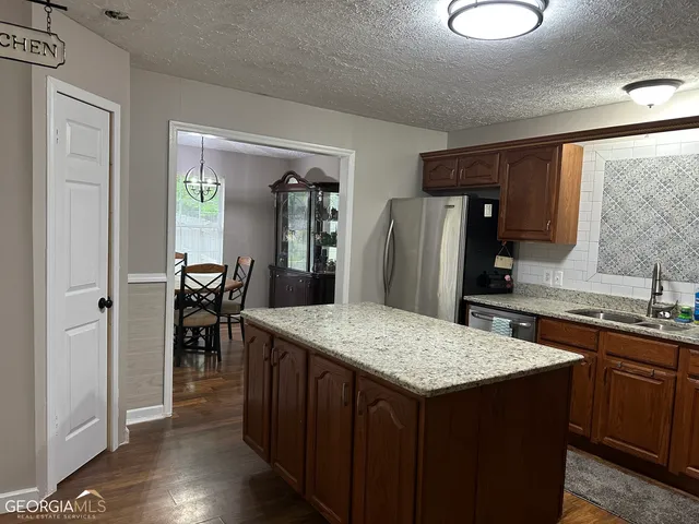 a kitchen with a table and chairs