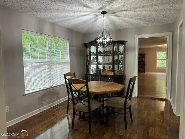 a view of a dining room with furniture window and wooden floor