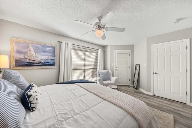 a bedroom with a large bed and a window