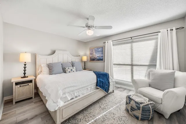 a bedroom with a bed a couch and a window