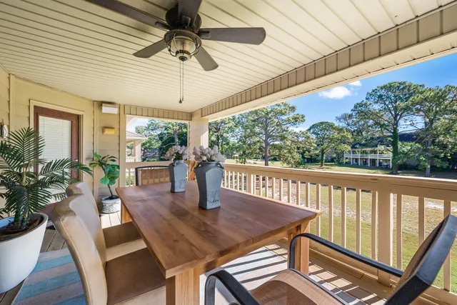 a view of a patio with a table chairs and wooden floor