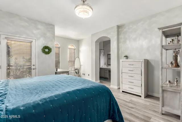 a spacious bedroom with a bed and a cabinets